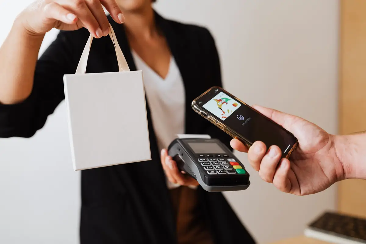 Phone held over a card reader for a contactless payment