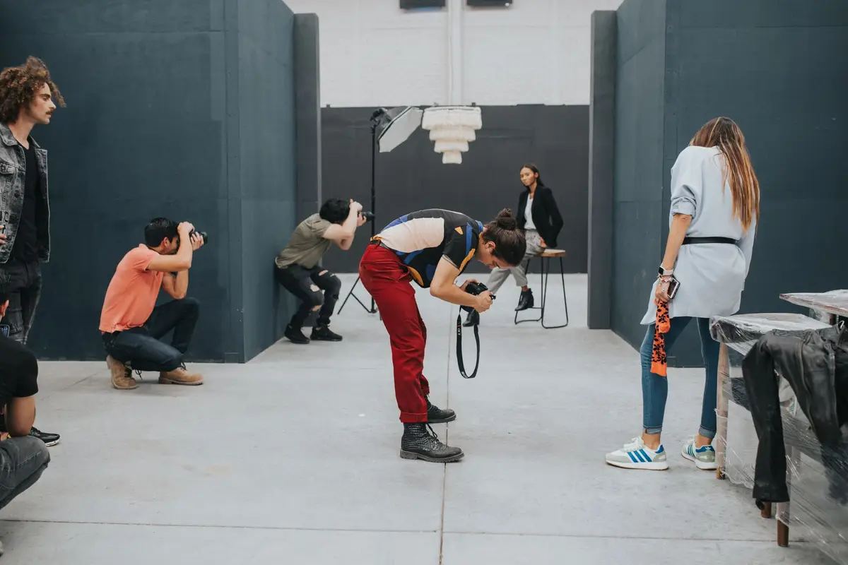 Photographers shooting a model in a studio