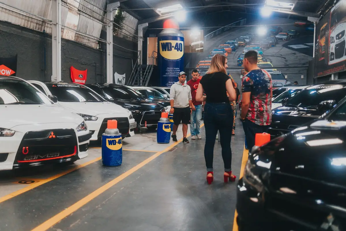 Enthusiasts looking at a line of performance sedans