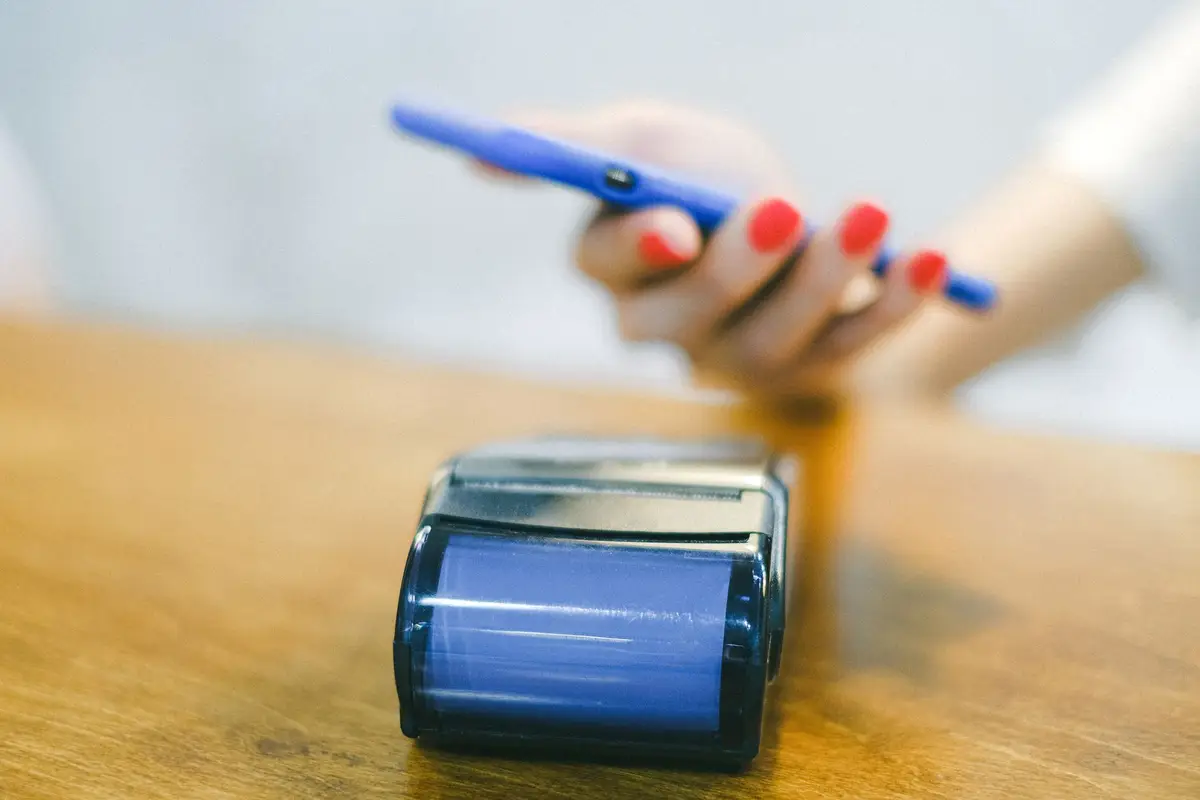 Phone used for a contactless payment at a shop counter