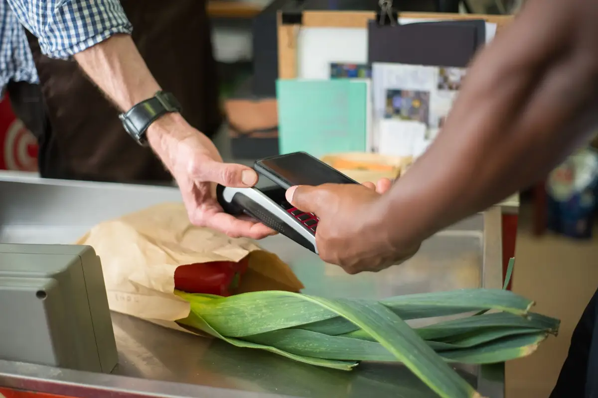 Customer paying by phone at a counter