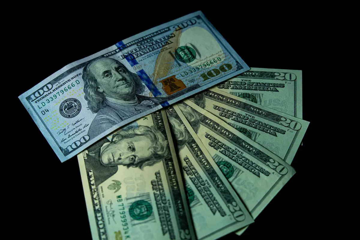 US dollar bills on a black background