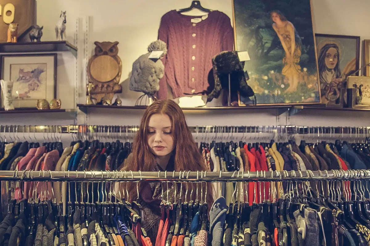 Shopper browsing racks in a vintage clothing shop