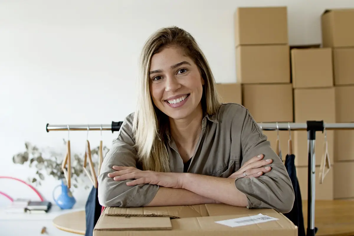 Online store owner with packages and clothes