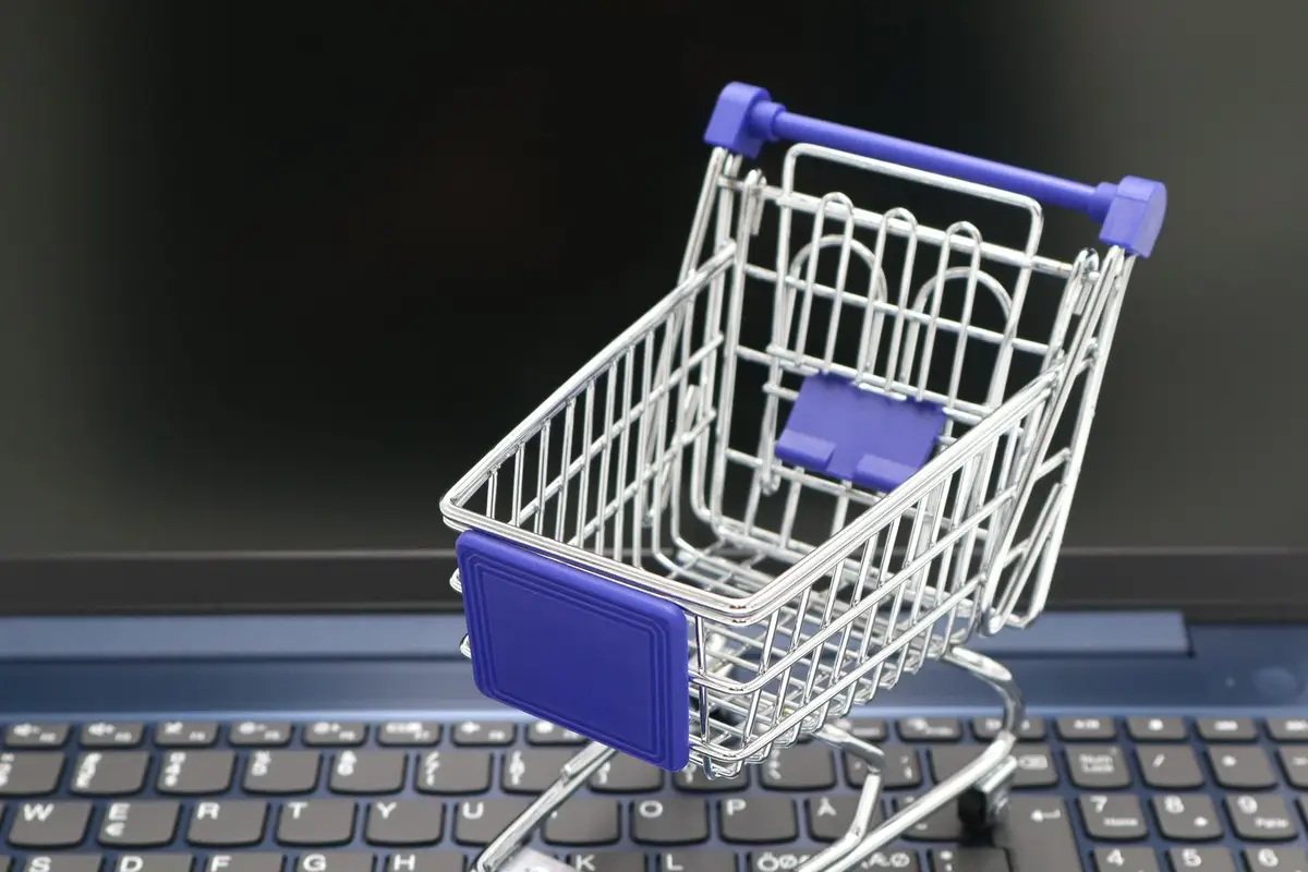Small shopping cart on a laptop keyboard