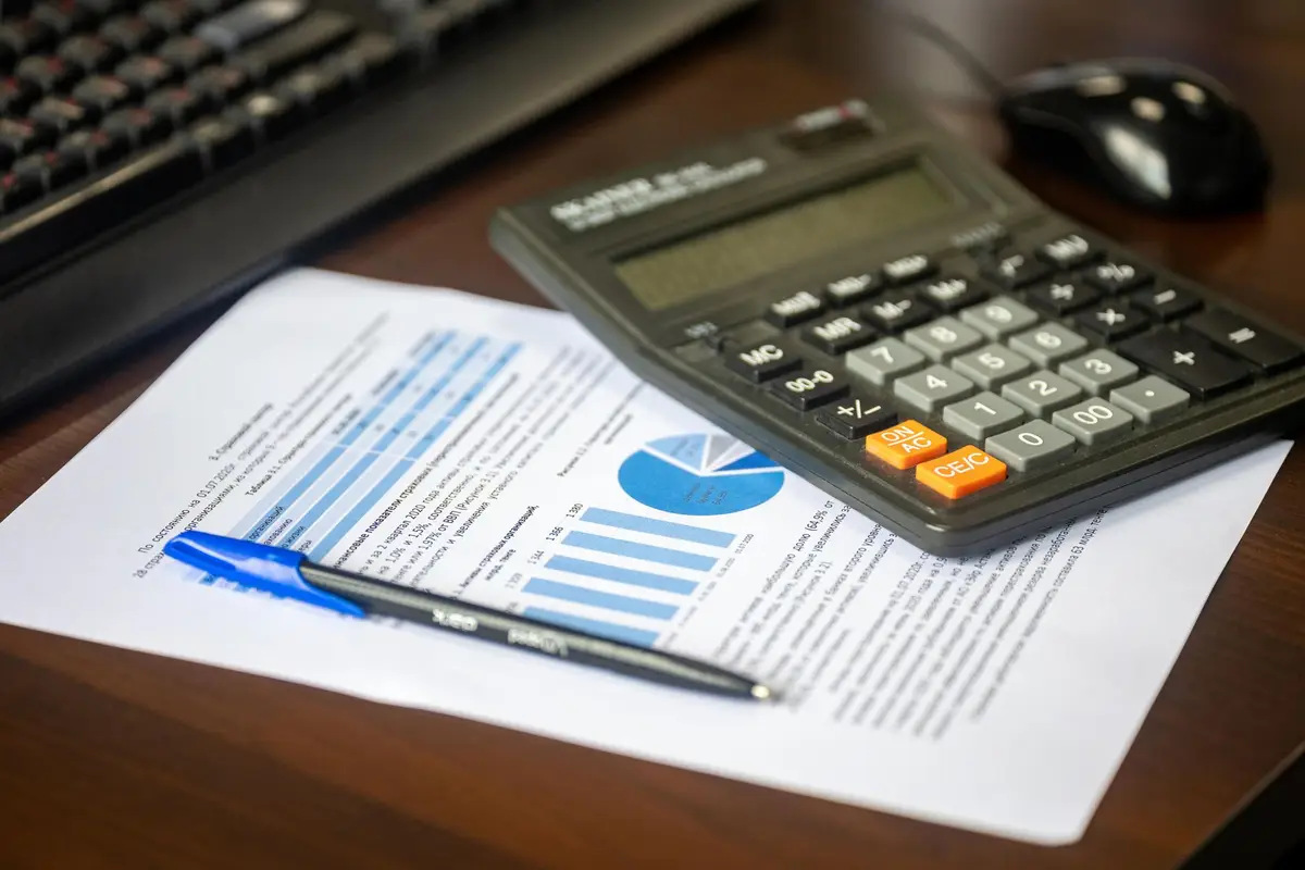 Desk with a calculator and a financial report