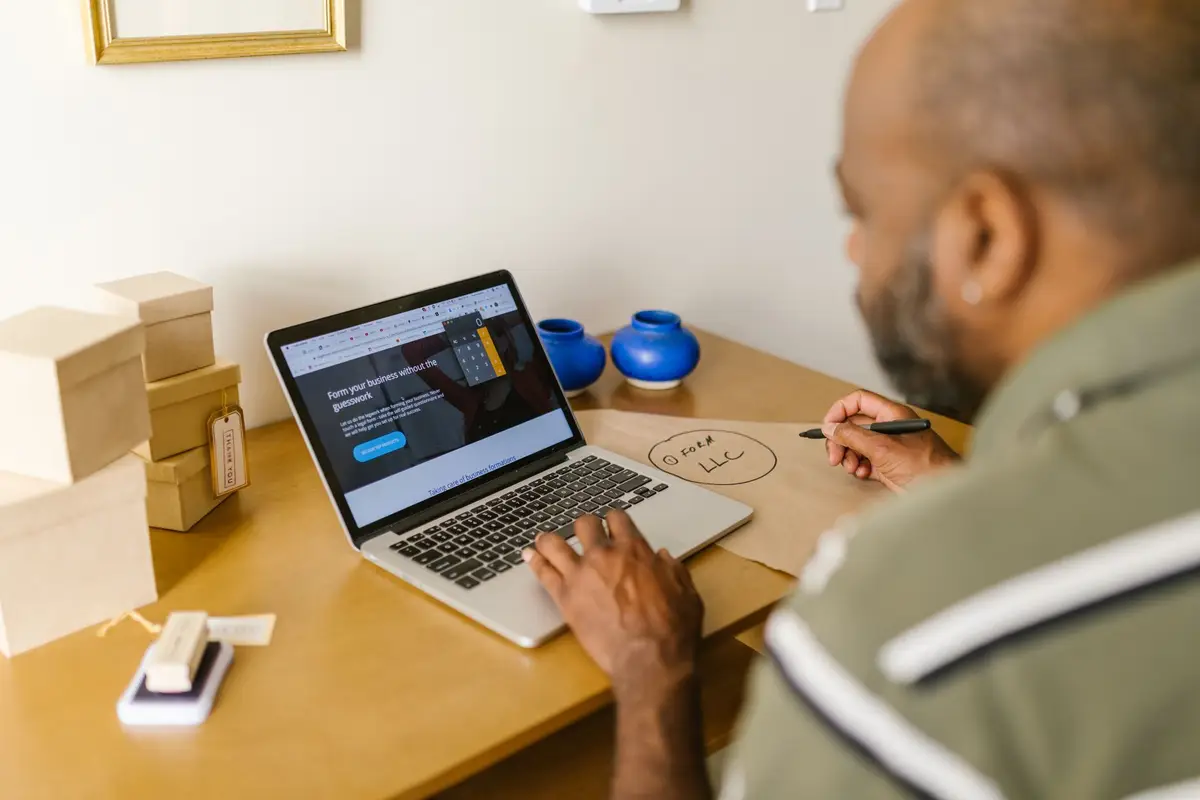 Business owner working on a laptop at a desk