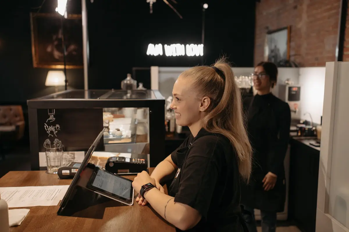 Barista serving customers at a café counter