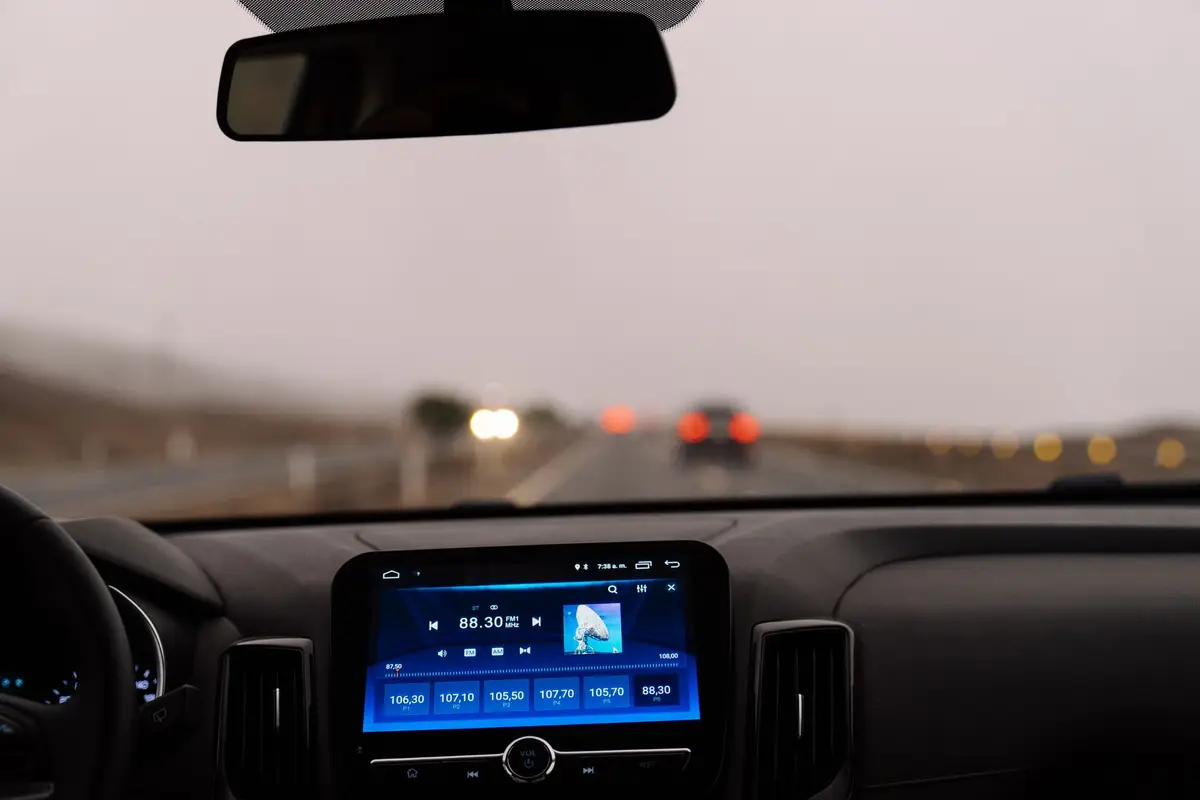 Car dashboard on an open road