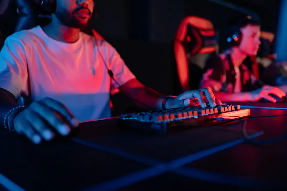 Gamers in a neon-lit arena wearing headphones