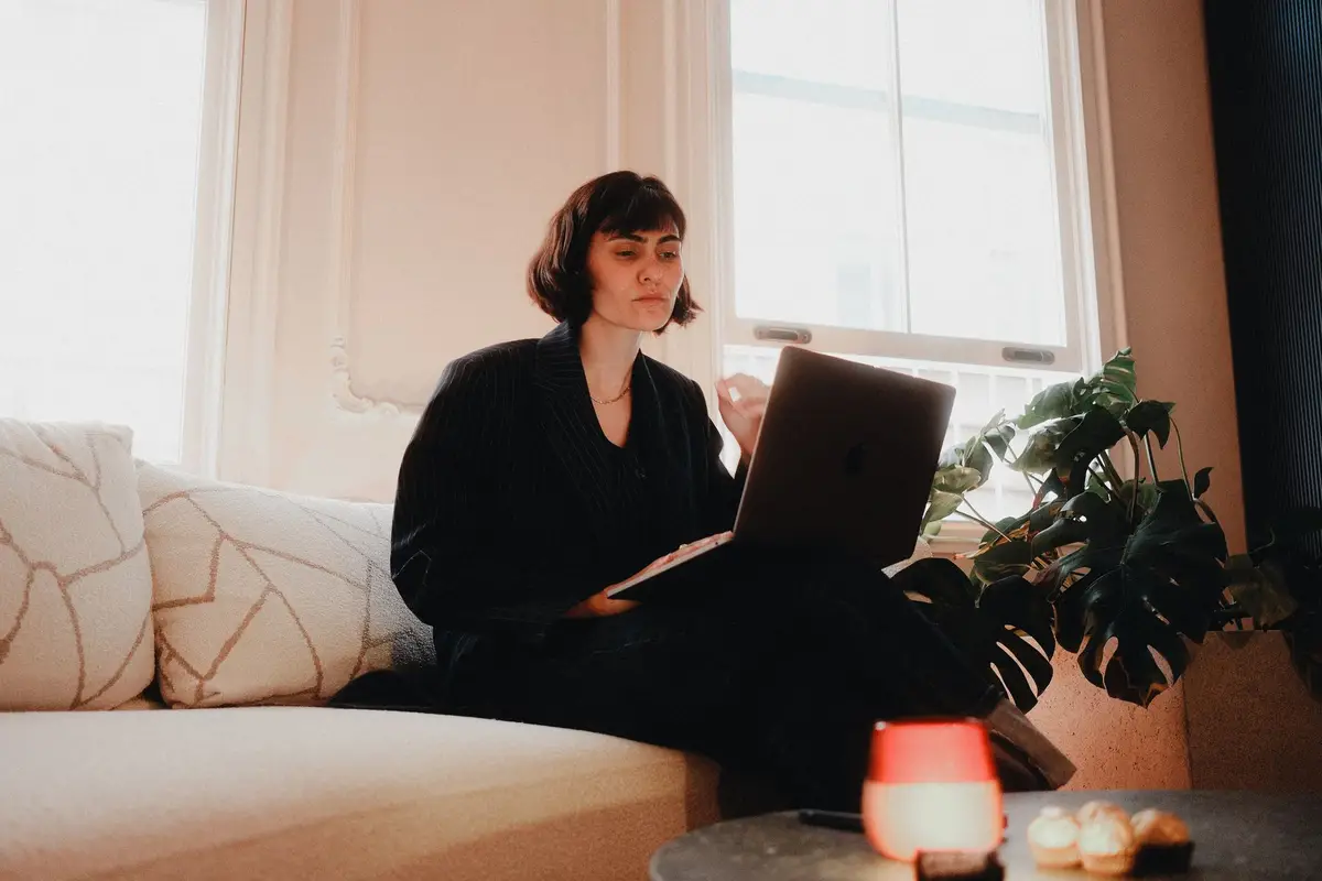 Woman working on a laptop in a bright room