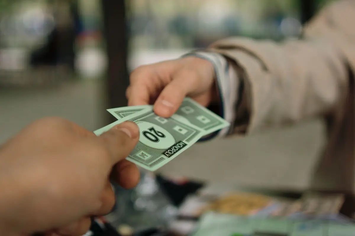 Hands exchanging play money