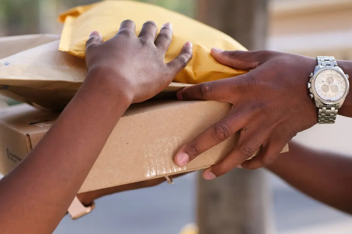Two people exchanging parcels