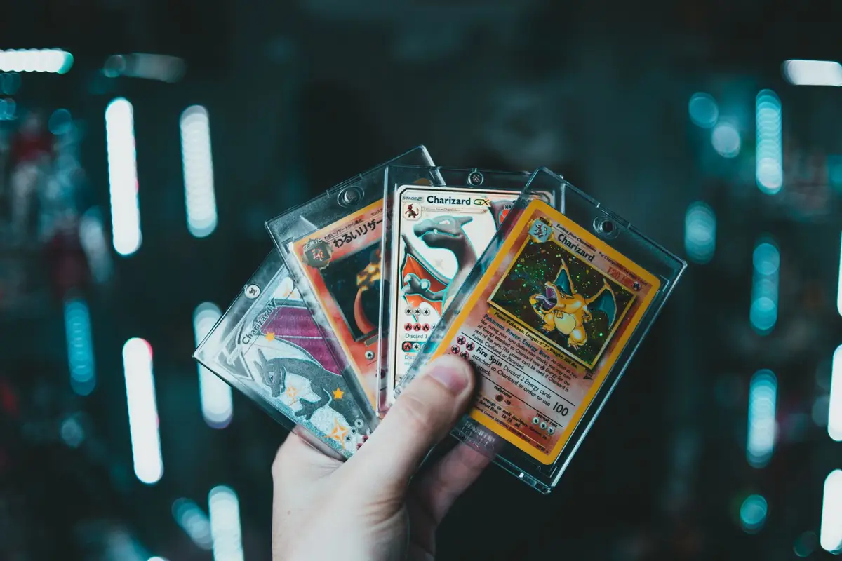 Hand holding collectible Charizard cards