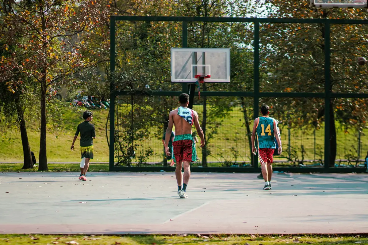 Teenagers playing basketball outdoors