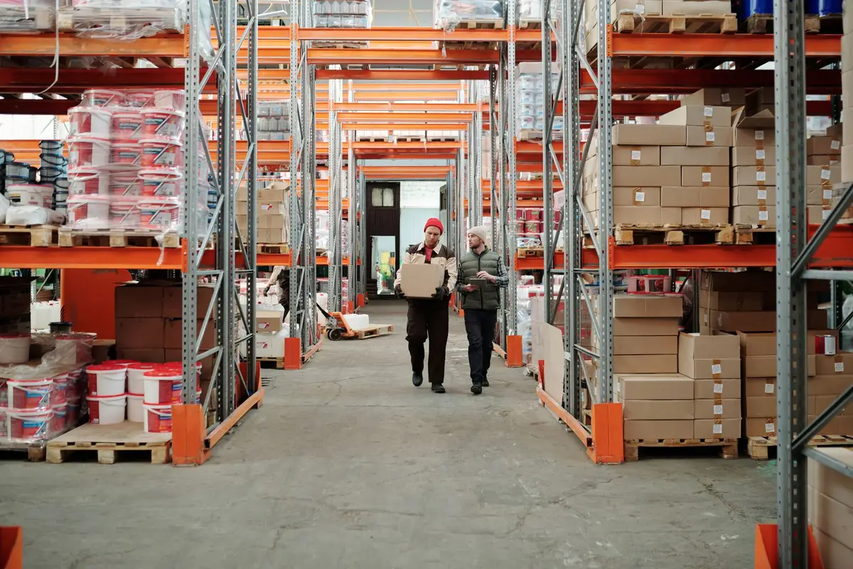 Workers handling a package in a warehouse